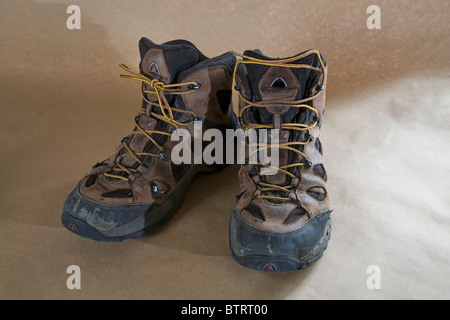 A pair of worn out lace up hiking boots. Stock Photo