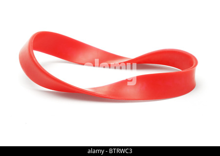 Twisted red rubber wrist band on white background Stock Photo