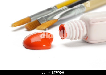 Red water color paint and brushes on white background Stock Photo