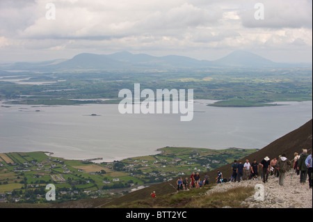 People climbing Croagh Patrick a holy mountain in County Mayo, Ireland. Stock Photo