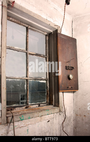 Old interior of a room in an old elizabethan pub with victorian electrical fittings Stock Photo