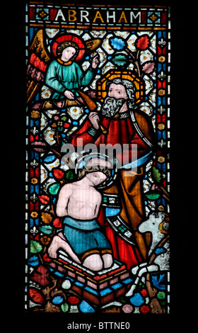 A stained glass window  by Alexander Gibbs (1867) depicting The Angel intervening to prevent Abraham sacrificing his son Isaac Stock Photo