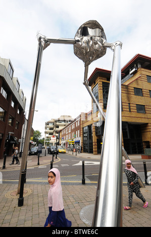 Woking commemorates writer H G Wells with a statue of a Martian fighting machine in the town centre. Stock Photo