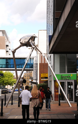 Woking commemorates writer H G Wells with a statue of a Martian fighting machine in the town centre. Stock Photo