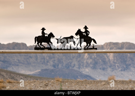 Ranch gate at Chihuahuan Desert near Presidio, Texas, USA with Sierra Grande massif across Rio Grande in Mexico in dist, winter Stock Photo