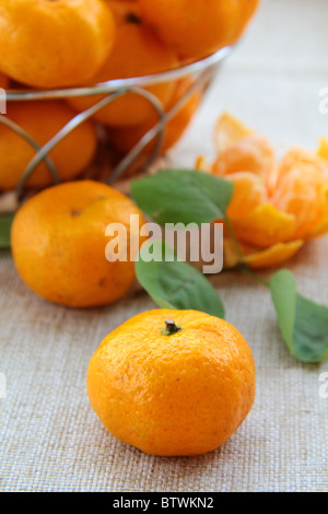 Fresh mandarin orange in a basket on the table Stock Photo