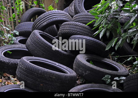 A large pile of fly tipped tyres dumped on waste ground in Brighton Stock Photo