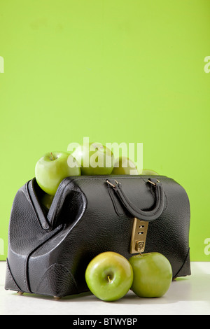 Doctors bag with green apples Stock Photo