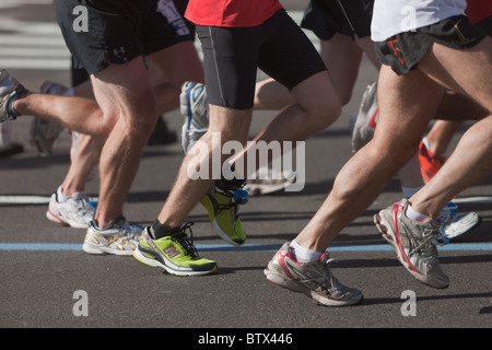 The legs and feet of runners during the 2010 New York City Marathon. Stock Photo