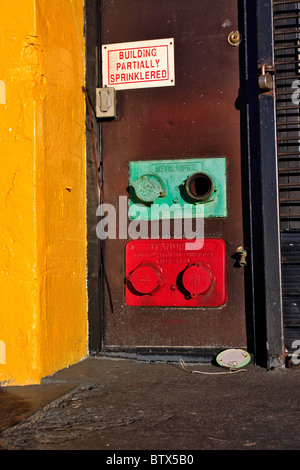 Fire Department connections on industrial building New York City Stock Photo