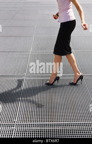 side view of business woman balancing on high heels. Copy space