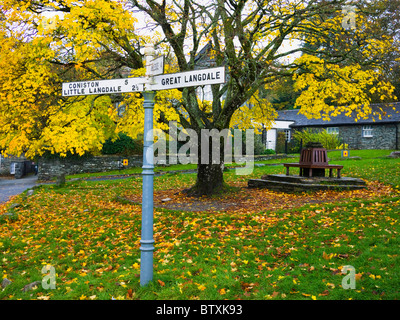 Signpost on the village green at Elterwater in the Lake District National Park, Cumbria, England. Stock Photo