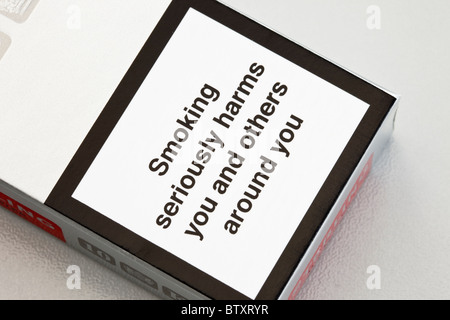 UK, Europe. Health warning on a cigarette packet 'Smoking seriously harms you and others around you' Stock Photo