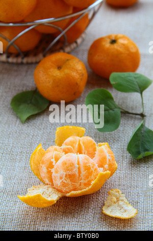 Fresh mandarin orange in a basket on the table Stock Photo