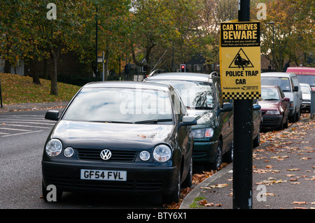 Sign warning of the use of a Police Trap Car in an attempt to deter car thieves Stock Photo