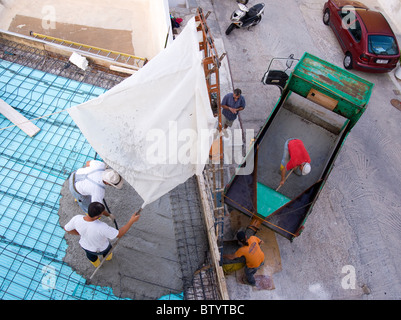 Greek construction workers redoing the roof of a house. Stock Photo