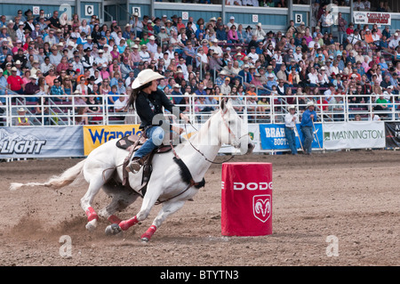 Cowgirl riding fast during barrel racing, Strathmore Heritage Days, Rodeo, Strathmore, Alberta, Canada Stock Photo