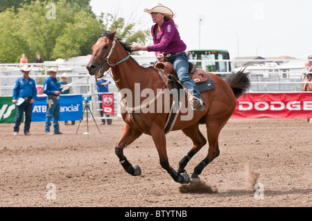 Cowgirl riding fast during barrel racing, Strathmore Heritage Days, Rodeo, Strathmore, Alberta, Canada Stock Photo