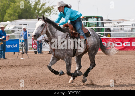 Cowgirl riding fast during barrel racing, Strathmore Heritage Days, Rodeo, Strathmore, Alberta, Canada Stock Photo