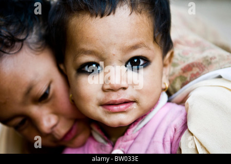 Hugging her little brother. Stock Photo