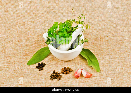 Ceramic pestle of thyme, parsley, and rosemary Stock Photo