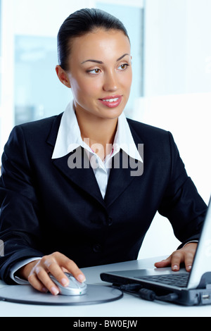 Image of young successful employer looking at laptop on workplace Stock Photo