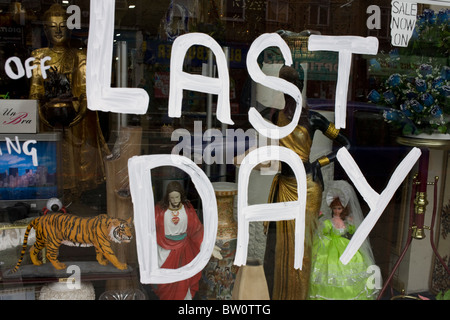 The words 'Last Day' are painted in white emulsion on a window Camden North London, England Stock Photo