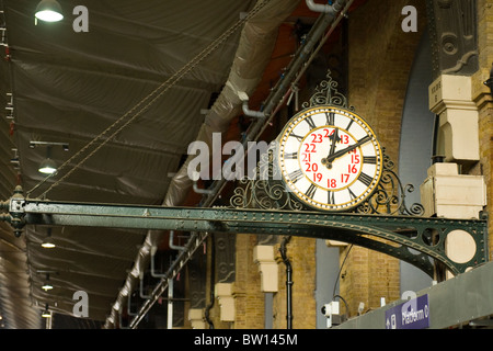 Kings Cross Station , ancient analogue clock perched on steel bracket or arm Stock Photo