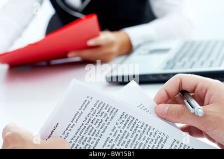Close-up of businessman hand holding papers and pen Stock Photo
