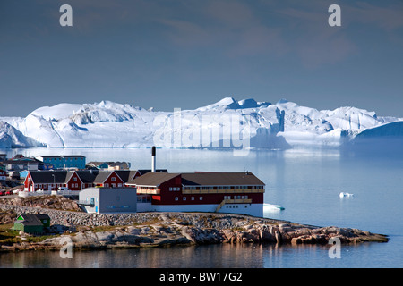 Icebergs and colourful houses in the town Ilulissat / Jakobshavn, Disko-Bay, Greenland Stock Photo