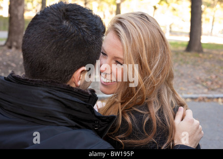 A young couple in New York's Central Park gaze happily at each other Stock Photo