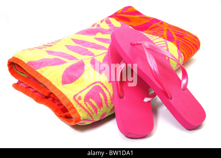 Beach towel and flip flops isolated on white background. Stock Photo