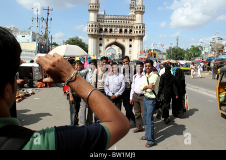 View of Indian tourists being photographed in front of the Charminar, Hyderabad Andhra Pradesh India Stock Photo