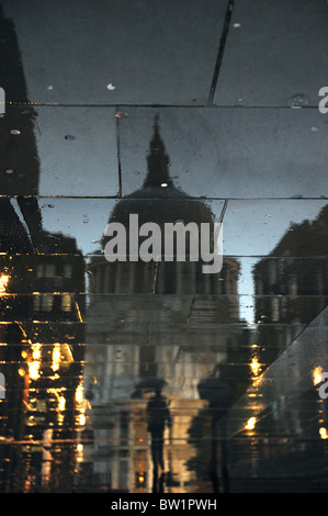 Reflection of someone walking in the rain in front of St Paul's Cathedral, London, United Kingdom Stock Photo
