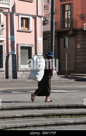 Woman carrying basket Plaza Santo Domingo, Historic Center, Quito, Ecuador. Stock Photo