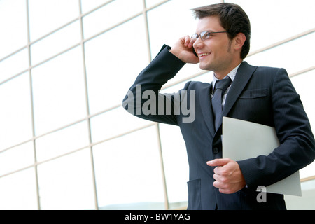 Portrait of confident businessman communicating by phone Stock Photo
