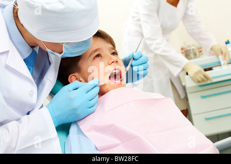 Image of dental examining being given to little boy by dentist Stock Photo