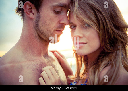Young couple embrace on beach Stock Photo