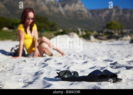 Woman on Camps Bay beach with Twelve Apostles in background, Cape Town, Western Cape, South Africa Stock Photo
