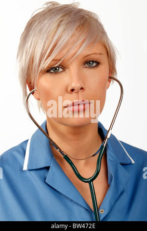Young female doctor listening through a stethoscope Stock Photo