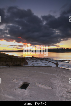 Purton sunset across river Severn and stranded barges Stock Photo