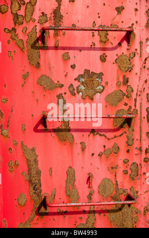 Metal ladders on red container wall Stock Photo