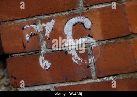 The number 76 seventy six painted on a brick wall in Brighton, East Sussex, UK. Stock Photo