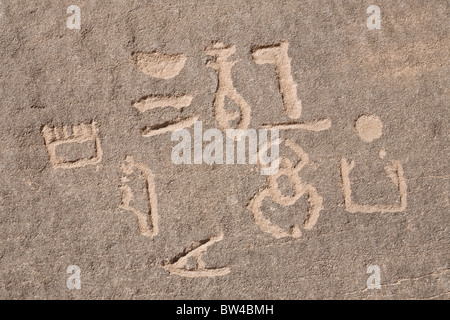 Carved hieroglyphs etched on cliff wall in Wadi Barramiya in the Eastern Desert of Egypt Stock Photo