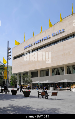 Royal Festival Hall south façade on South Bank or Southbank leisure complex 3 single chairs bolted down on paving & outdoor eating facility London UK Stock Photo