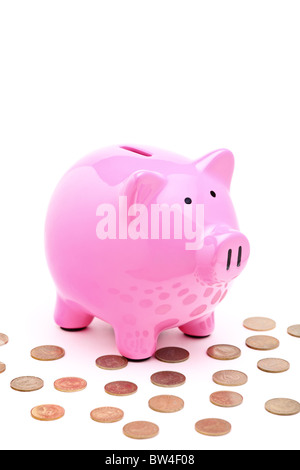 A view of a pink piggy bank and many coins Stock Photo