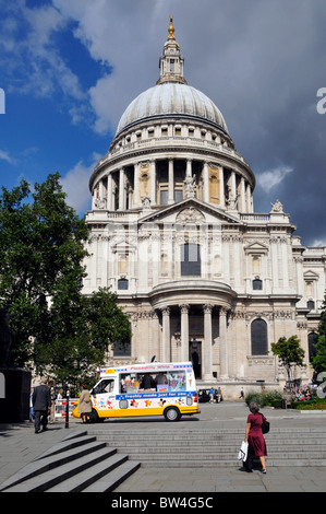 Van selling & serving ice cream parked outside historic St Pauls Cathedral on busy tourist pedestrian route in City of London England UK Stock Photo