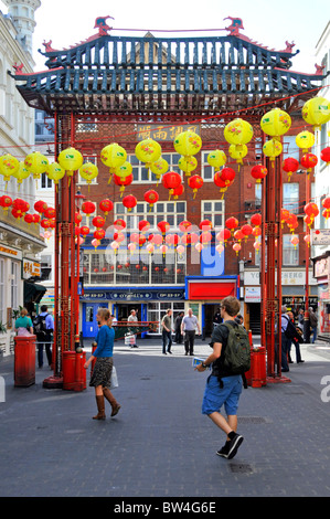 Chinese decorations & colourful lanterns around Chinatown gateway West End London tourism and shopping scene in Gerrard Street China Town England UK Stock Photo