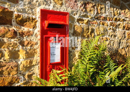 Rural red royal mail  post box on wall Stock Photo