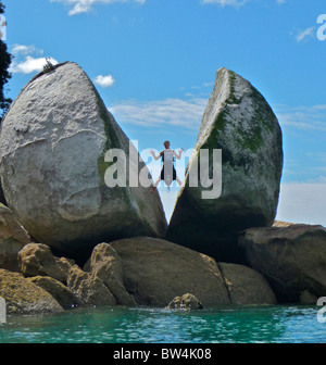 A unique rock formation known as Split Apple Rock surfaces out of the Tasman Sea in Abel Tasman National Park, New Zealand. Stock Photo